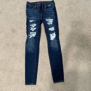 Dark wash skinny jeans with rips